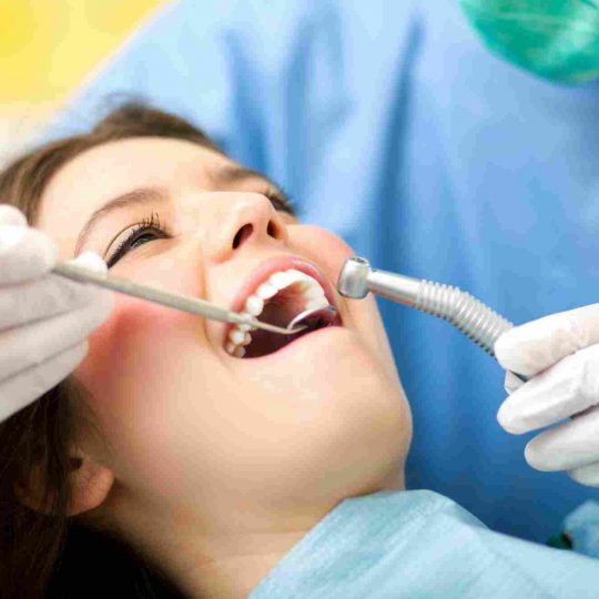 female dental patient receiving dental care